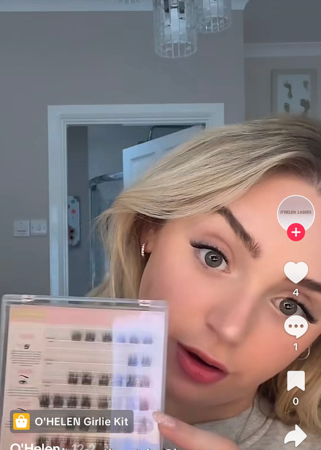 Social video still of a blonde woman holding an O’HELEN lash tray beside her face.