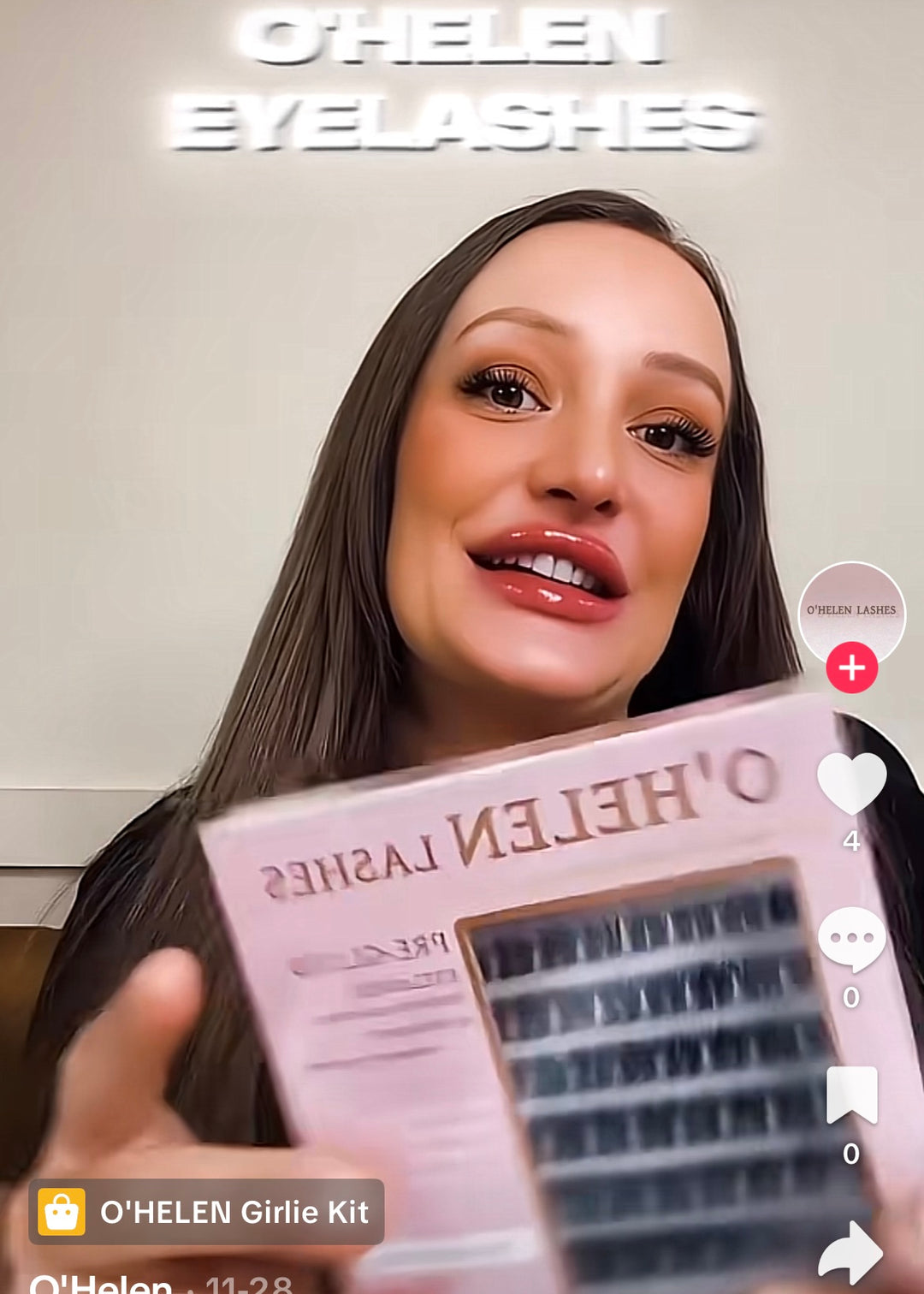 Social video still of a brunette woman presenting a pink O’HELEN lash pack.