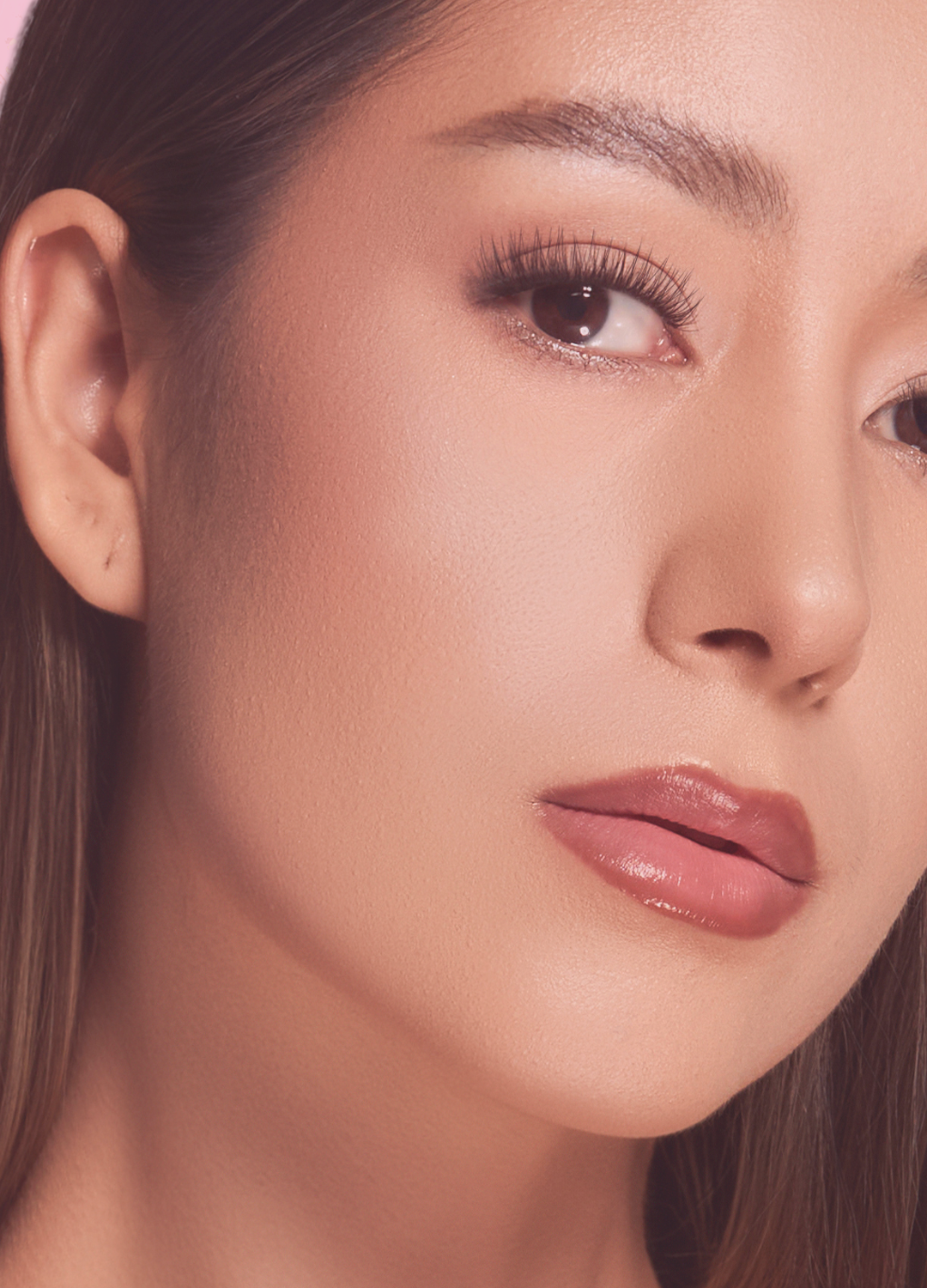 Close-up beauty portrait showing a woman with curled upper lashes.