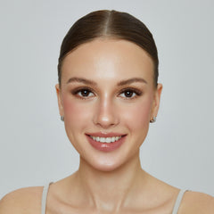 Smiling model wearing the Cocoa Noir lash look against a gray background.
